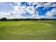 Scenic view of a well-maintained golf course with manicured greens and a clear blue sky backdrop at 18168 Clearview Dr, Brooksville, FL 34604