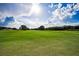 Expansive golf course featuring a vibrant green fairway under a sunny, partly cloudy sky at 18168 Clearview Dr, Brooksville, FL 34604