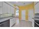 Bright kitchen featuring white cabinets, tile backsplash, and ample counter space at 18168 Clearview Dr, Brooksville, FL 34604