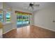 Bright room with wood floors and sliding doors that look out to the pool at 18168 Clearview Dr, Brooksville, FL 34604