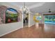 Bright living room featuring hardwood floors and a unique wall mural at 18168 Clearview Dr, Brooksville, FL 34604