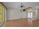 Open-concept living room with sliding doors, wood floors, bright walls and lots of natural light at 18168 Clearview Dr, Brooksville, FL 34604