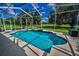 Beautiful screened-in pool with bright blue water and lovely landscaping in a private backyard at 18168 Clearview Dr, Brooksville, FL 34604