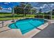 Screened-in pool and patio with ample seating and a view of the backyard at 18168 Clearview Dr, Brooksville, FL 34604