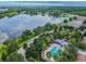 Beautiful aerial shot of a community with a pool and lake at 18203 Tivoli Ln, Lutz, FL 33558