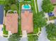 Home with pool in aerial view. Perfectly manicured lawn with a clean roof and surrounding landscape at 18203 Tivoli Ln, Lutz, FL 33558