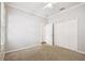 Bright bedroom with neutral walls, carpet flooring, and double door closet at 18203 Tivoli Ln, Lutz, FL 33558