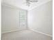 This bedroom has neutral paint, carpet, and a window at 18203 Tivoli Ln, Lutz, FL 33558
