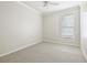 This bedroom has neutral paint, carpet, and a window at 18203 Tivoli Ln, Lutz, FL 33558