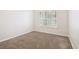 Neutral bedroom with plush carpeting, a double window, and white trim at 18203 Tivoli Ln, Lutz, FL 33558