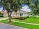 A charming single-Gathering home with a lush green lawn and mature trees at 18203 Tivoli Ln, Lutz, FL 33558