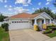Inviting exterior view of a single-Gathering home with an attached two-car garage at 18203 Tivoli Ln, Lutz, FL 33558