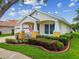 Inviting single-story home with a well-kept lawn and a charming front porch at 18203 Tivoli Ln, Lutz, FL 33558