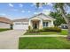 Charming single-story home with a well-manicured lawn and inviting front porch at 18203 Tivoli Ln, Lutz, FL 33558