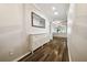 Hallway with hardwood floors, modern decor, and natural light at 18203 Tivoli Ln, Lutz, FL 33558