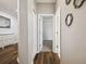 Hallway with hard wood floors leading to a bedroom with carpet at 18203 Tivoli Ln, Lutz, FL 33558