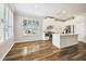 Bright, modern kitchen featuring an island with marble countertops and wood floors at 18203 Tivoli Ln, Lutz, FL 33558