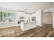 Modern kitchen with an island, stainless steel appliances, and stylish hardwood flooring at 18203 Tivoli Ln, Lutz, FL 33558