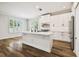 Bright kitchen with white cabinets, island, and stainless steel appliances at 18203 Tivoli Ln, Lutz, FL 33558