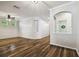 Inviting living room with arched doorways and beautiful hardwood floors at 18203 Tivoli Ln, Lutz, FL 33558