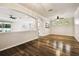 Open-concept living space showcasing hardwood floors and seamless flow to the kitchen at 18203 Tivoli Ln, Lutz, FL 33558