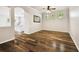 Open-concept living room with hardwood floors and natural light from large windows at 18203 Tivoli Ln, Lutz, FL 33558