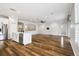 Open-concept living area boasts wood floors, white trim, recessed lighting, and a ceiling fan at 18203 Tivoli Ln, Lutz, FL 33558