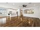 Open-concept living space featuring white trim, hardwood flooring, and modern finishes at 18203 Tivoli Ln, Lutz, FL 33558