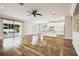 Bright, open living space featuring hardwood floors, recessed lighting, and a modern ceiling fan at 18203 Tivoli Ln, Lutz, FL 33558
