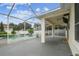 Covered patio area with a screened enclosure, offering ample space for seating and enjoying the outdoors at 18203 Tivoli Ln, Lutz, FL 33558