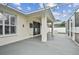 Enclosed patio space with outdoor lighting creates a cozy and inviting atmosphere for relaxing or entertaining guests at 18203 Tivoli Ln, Lutz, FL 33558
