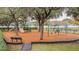 Inviting community playground featuring swings, slides, and play equipment, surrounded by mature trees at 18203 Tivoli Ln, Lutz, FL 33558