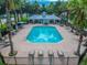 Inviting community pool area with sun loungers, tables, and chairs for residents to relax and enjoy at 18203 Tivoli Ln, Lutz, FL 33558