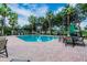 Relaxing community pool area with ample seating and lush landscaping, ideal for socializing and unwinding at 18203 Tivoli Ln, Lutz, FL 33558