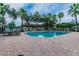 Community pool featuring tables, chairs, and sun loungers, perfect for relaxation and recreation at 18203 Tivoli Ln, Lutz, FL 33558