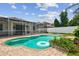 Backyard pool with brick paver deck, spa and screened enclosure at 18203 Tivoli Ln, Lutz, FL 33558