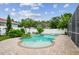 Inviting backyard pool area with lush landscaping and a charming brick-paved patio, perfect for relaxation at 18203 Tivoli Ln, Lutz, FL 33558