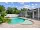 Backyard pool with brick paver deck, spa and screened enclosure at 18203 Tivoli Ln, Lutz, FL 33558