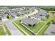 The aerial view reveals a home's backyard lawn and screened in patio, within a fenced yard and neighborhood location at 18527 Cortes Creek Blvd, Spring Hill, FL 34610