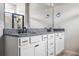 Bright bathroom showcasing a double vanity with granite countertops and modern fixtures at 18527 Cortes Creek Blvd, Spring Hill, FL 34610