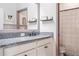 Bathroom featuring a granite countertop, modern fixtures, and a decorative mirror at 18527 Cortes Creek Blvd, Spring Hill, FL 34610