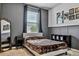 Comfortable bedroom features neutral colored walls, carpeted floor, and decorative wainscotting at 18527 Cortes Creek Blvd, Spring Hill, FL 34610
