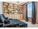 Cozy bedroom features a full wall of built-in bookshelves and a comfortable daybed at 18527 Cortes Creek Blvd, Spring Hill, FL 34610