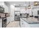 Kitchen showcasing stainless steel appliances, granite countertops, and a breakfast bar with stylish pendant lighting at 18527 Cortes Creek Blvd, Spring Hill, FL 34610