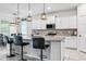 Spacious kitchen with stainless steel appliances, breakfast bar, and open layout to the dining area at 18527 Cortes Creek Blvd, Spring Hill, FL 34610
