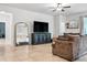 Living room featuring tile floors, neutral walls, media center, and stylish decor at 18527 Cortes Creek Blvd, Spring Hill, FL 34610