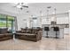 Open-concept living room with tile flooring, a comfortable sofa, and seamless access to the kitchen at 18527 Cortes Creek Blvd, Spring Hill, FL 34610