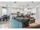 View of the living room into the kitchen, featuring stylish furnishings, modern lighting, and tile flooring at 18527 Cortes Creek Blvd, Spring Hill, FL 34610