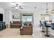 Open-concept living room flowing into the kitchen, featuring stylish furnishings and modern lighting at 18527 Cortes Creek Blvd, Spring Hill, FL 34610