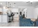 Living room flowing into the kitchen, featuring stylish furnishings, modern lighting, and tile flooring at 18527 Cortes Creek Blvd, Spring Hill, FL 34610